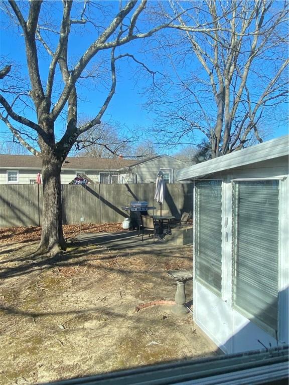 view of yard with a storage shed, fence, and an outbuilding