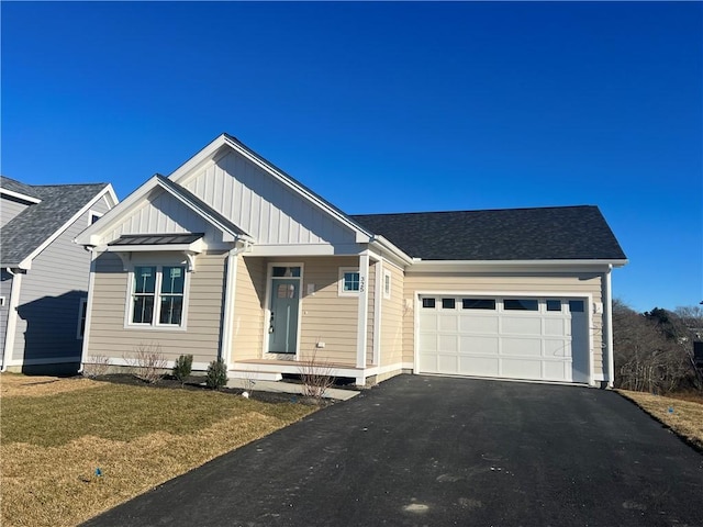 view of front of home with a garage and a front lawn