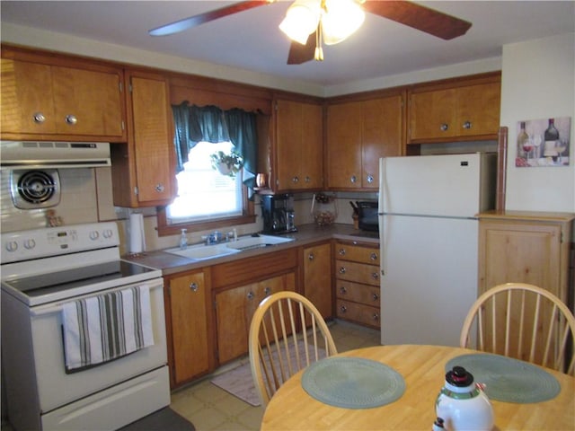 kitchen with ceiling fan, white appliances, and sink