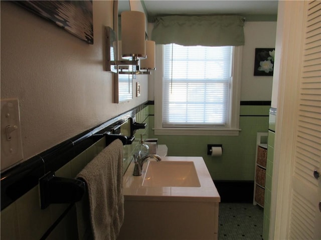 bathroom featuring vanity, a wealth of natural light, and tile walls