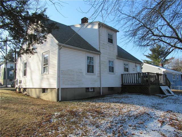 snow covered house featuring a wooden deck