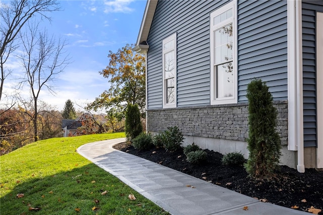 view of side of property with a lawn