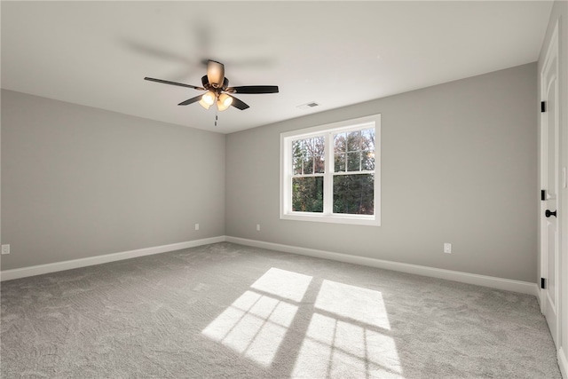 spare room featuring ceiling fan and light carpet