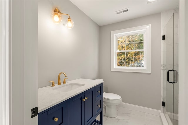 bathroom with a shower with door, vanity, and toilet