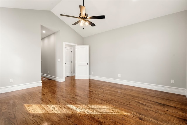 empty room with hardwood / wood-style flooring, ceiling fan, and high vaulted ceiling