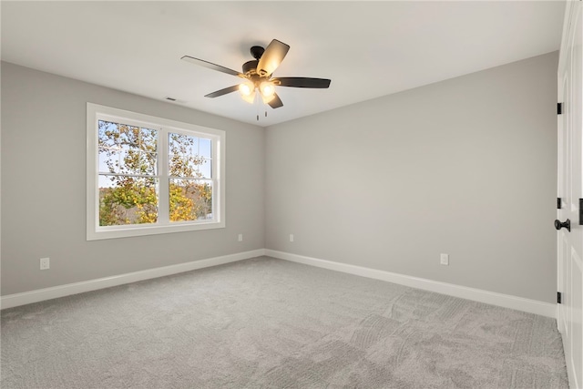 empty room with ceiling fan and carpet floors