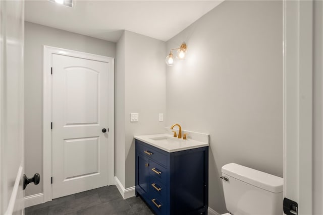 bathroom featuring tile patterned floors, vanity, and toilet