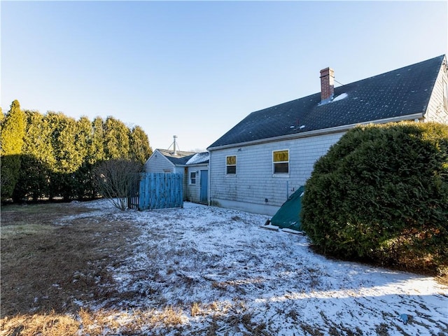 view of snow covered rear of property