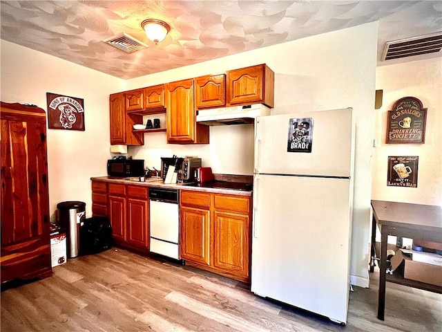 kitchen featuring sink, white appliances, and light hardwood / wood-style floors