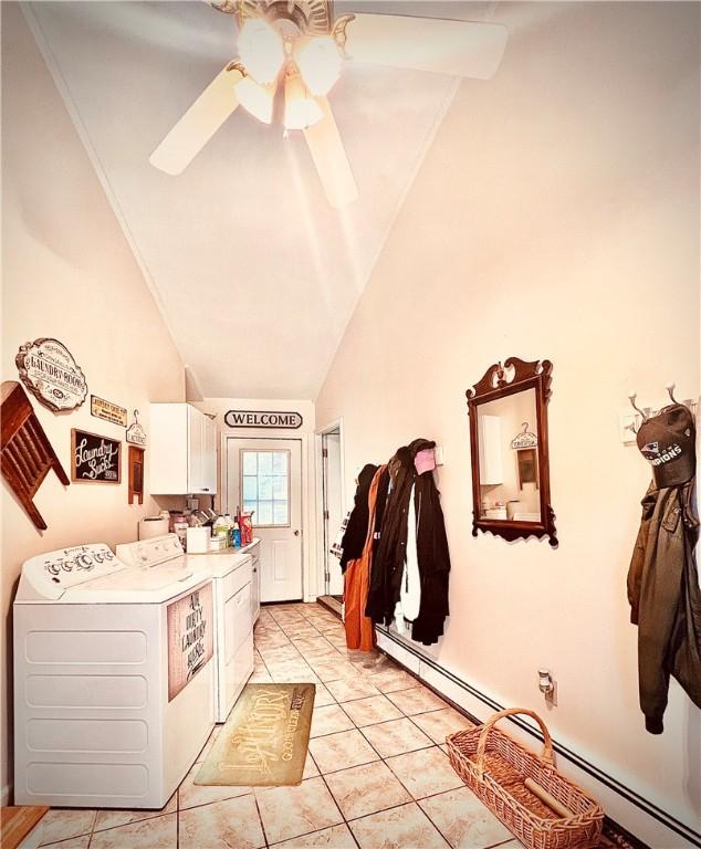 laundry area featuring cabinets, ceiling fan, light tile patterned flooring, washer and clothes dryer, and a baseboard radiator