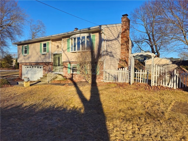 rear view of house with a garage