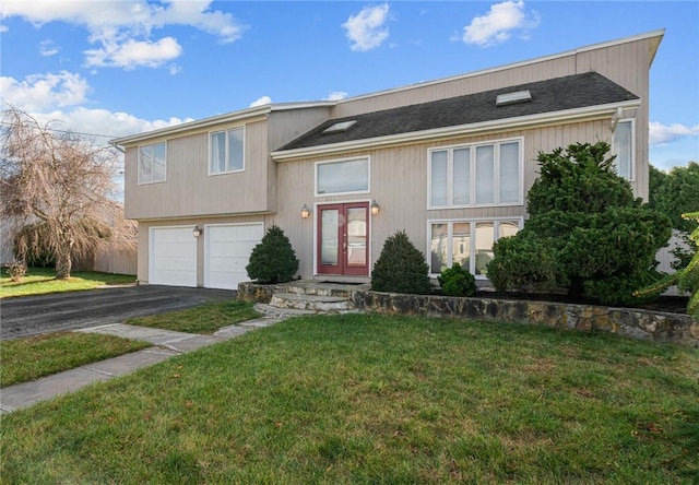 view of front facade with french doors, a garage, and a front lawn