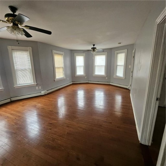 unfurnished room featuring ceiling fan, hardwood / wood-style floors, and a healthy amount of sunlight