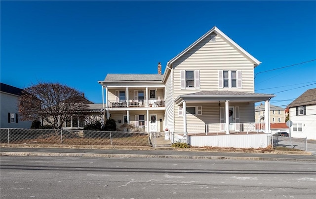 view of property featuring a balcony and a porch