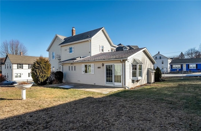 back of house with a patio area and a yard