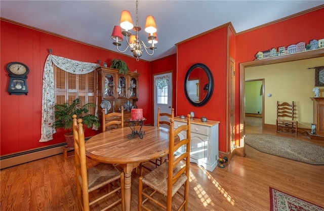 dining area featuring a baseboard heating unit, light hardwood / wood-style flooring, and an inviting chandelier