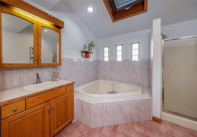 bathroom featuring tile patterned flooring, vanity, vaulted ceiling, and separate shower and tub