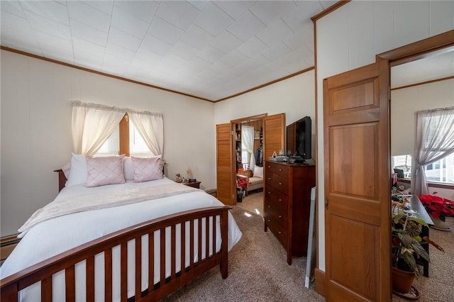 bedroom with carpet floors and crown molding