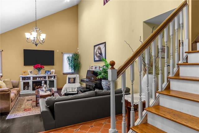 living room with a fireplace, high vaulted ceiling, a chandelier, and hardwood / wood-style flooring