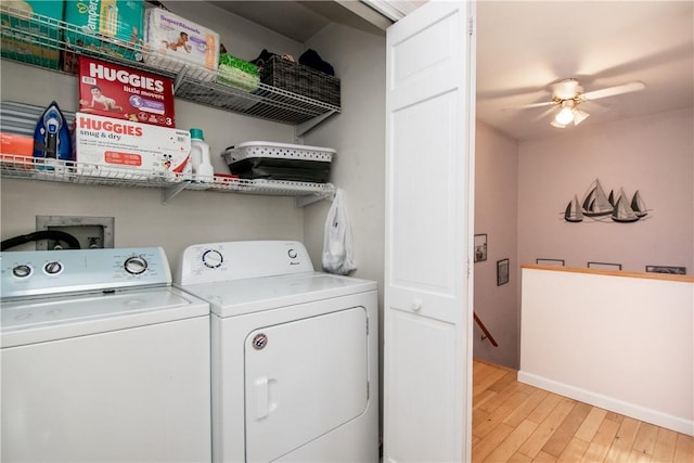 laundry area featuring ceiling fan, separate washer and dryer, and light wood-type flooring