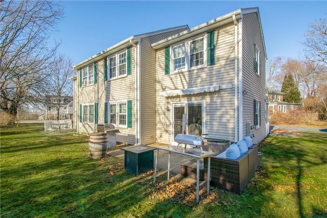 back of property featuring a lawn and an outdoor hangout area