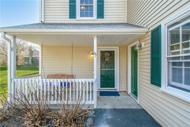 view of exterior entry with covered porch