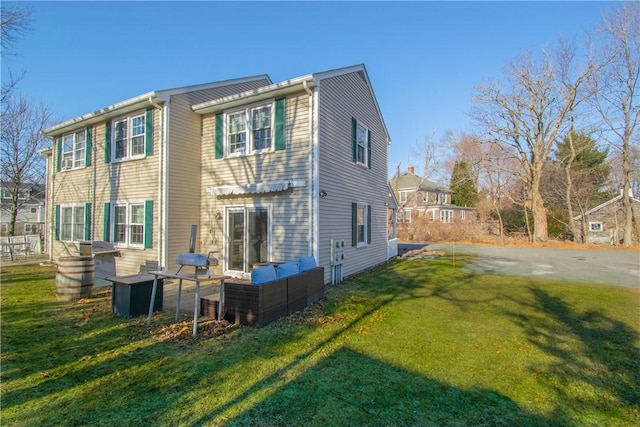 rear view of property with a yard