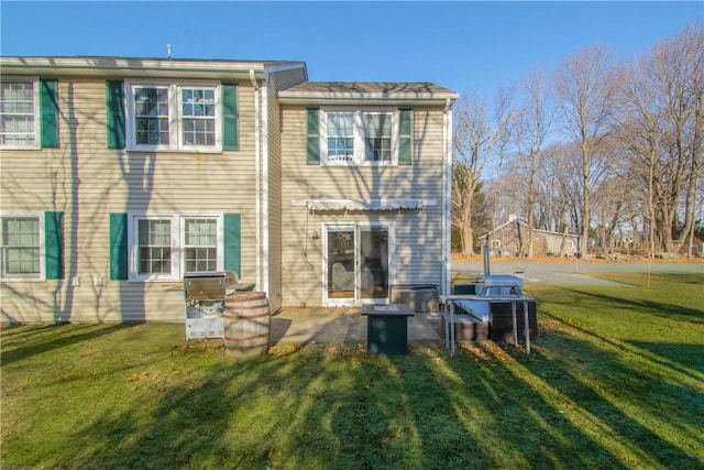 back of house with a patio and a yard