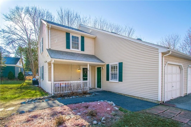 view of front of home featuring covered porch and a garage