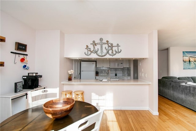 dining room with light hardwood / wood-style floors and sink