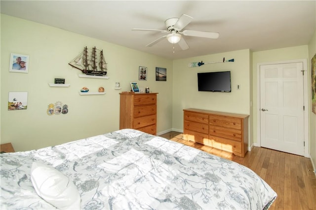 bedroom with ceiling fan and light hardwood / wood-style floors