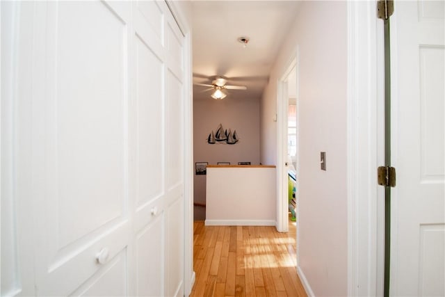 hallway with light hardwood / wood-style flooring