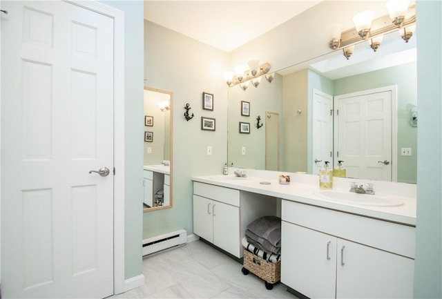 bathroom with baseboard heating and vanity