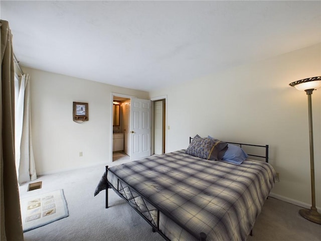 carpeted bedroom featuring connected bathroom