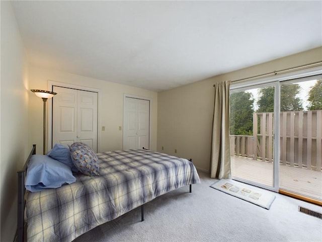 carpeted bedroom with multiple closets