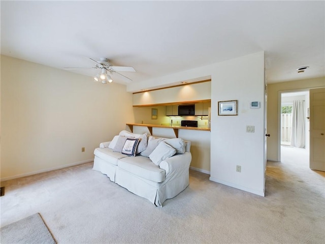 carpeted living room featuring ceiling fan