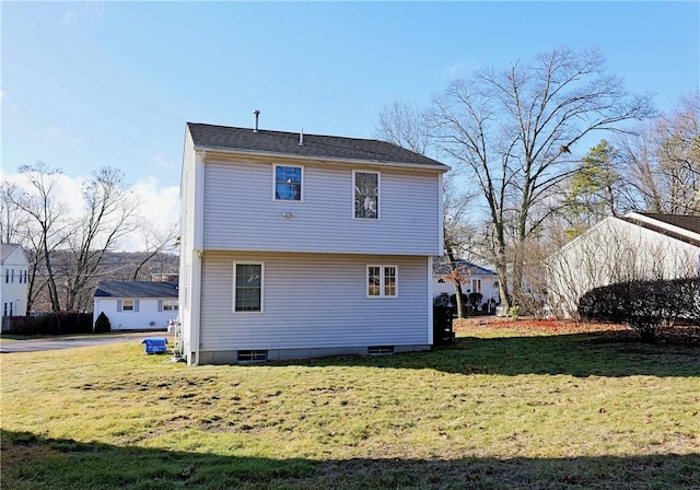 rear view of house with a lawn