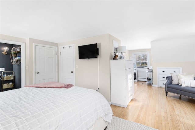 bedroom featuring light hardwood / wood-style flooring and baseboard heating