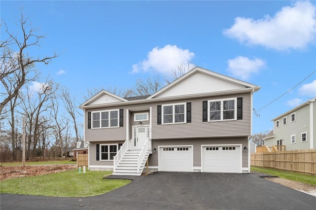 raised ranch with a garage and a front yard