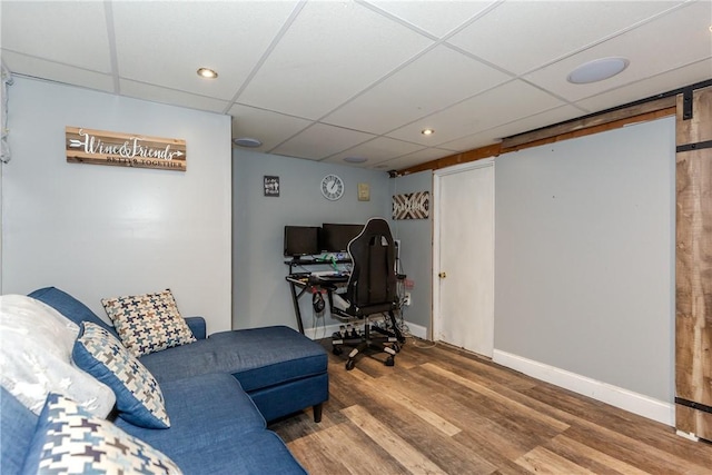 office space featuring hardwood / wood-style floors and a paneled ceiling