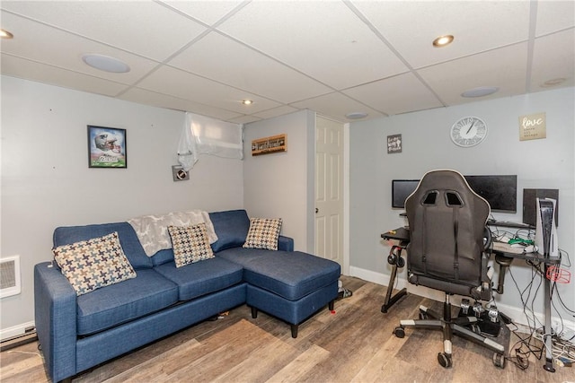 home office with hardwood / wood-style floors and a drop ceiling