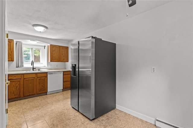 kitchen featuring dishwasher, sink, vaulted ceiling, baseboard heating, and stainless steel fridge with ice dispenser