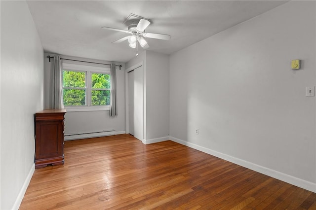 unfurnished room with a baseboard radiator, ceiling fan, and light hardwood / wood-style floors