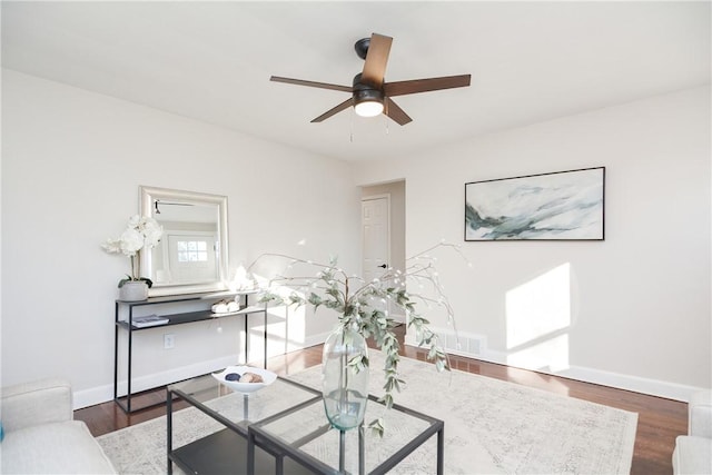 living room featuring ceiling fan and wood-type flooring