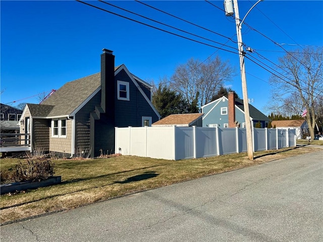 view of side of property with a lawn