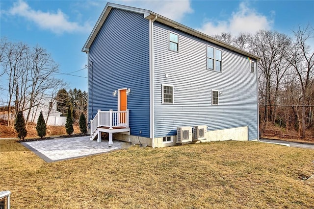 rear view of property featuring ac unit, a yard, and a patio