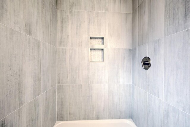 bathroom with a tile shower