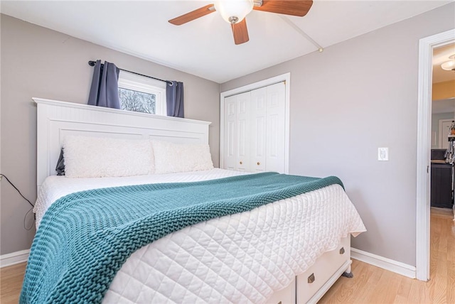 bedroom with ceiling fan, light hardwood / wood-style floors, and a closet