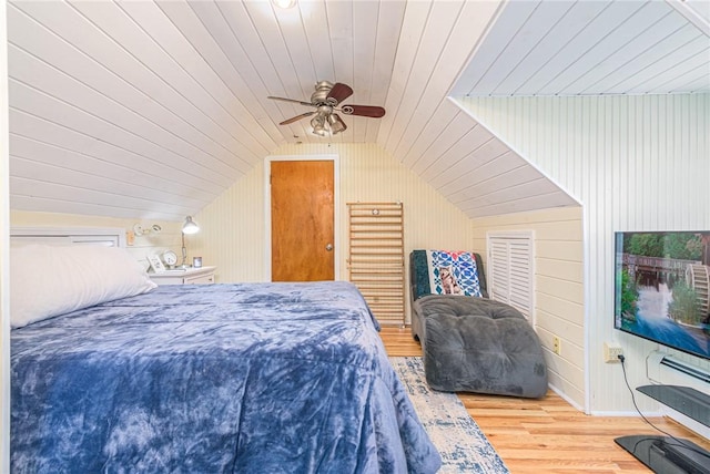 bedroom with ceiling fan, wooden ceiling, lofted ceiling, wooden walls, and hardwood / wood-style flooring