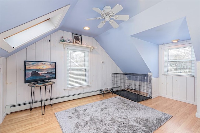 bonus room with ceiling fan, a wealth of natural light, and light hardwood / wood-style flooring